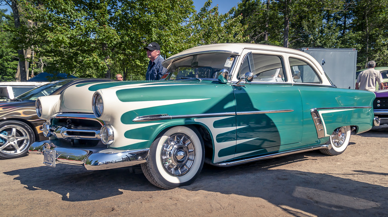 A 1952 Ford with a custom white and teal paint job.