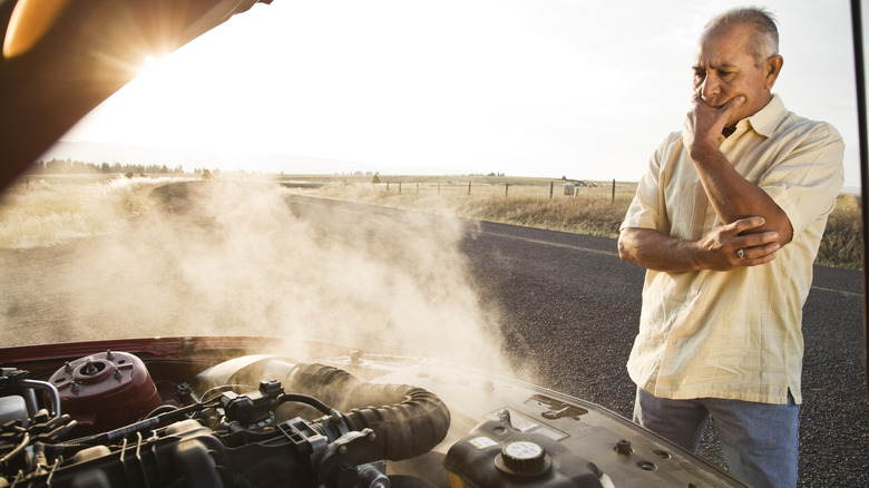 Man looking at smoking engine