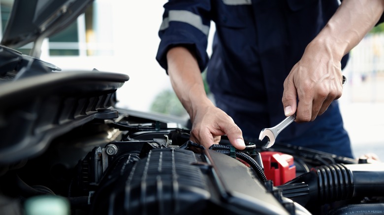 Mechanic working on car engine