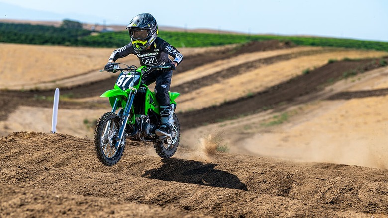 Kawasaki KX65 rider blitzing some whoops