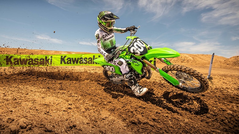 Kawasaki KX85 roosting the Kawasaki banner