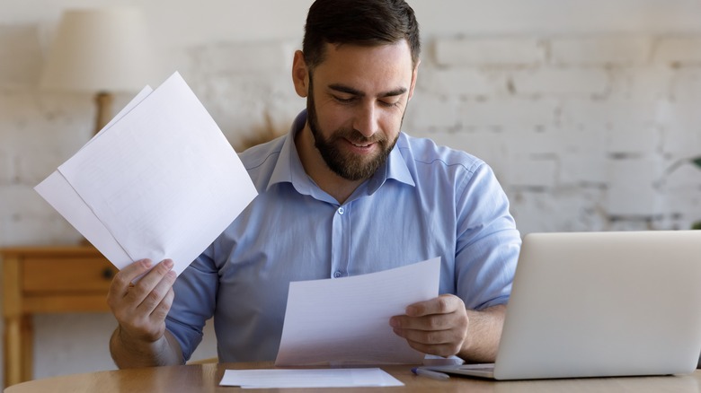 man reviewing insurance policy