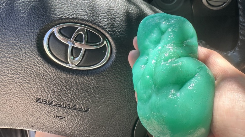 Dust cleaning gel next to Toyota decal on steering wheel