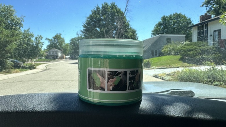 Dust cleaning gel in container sitting on dash