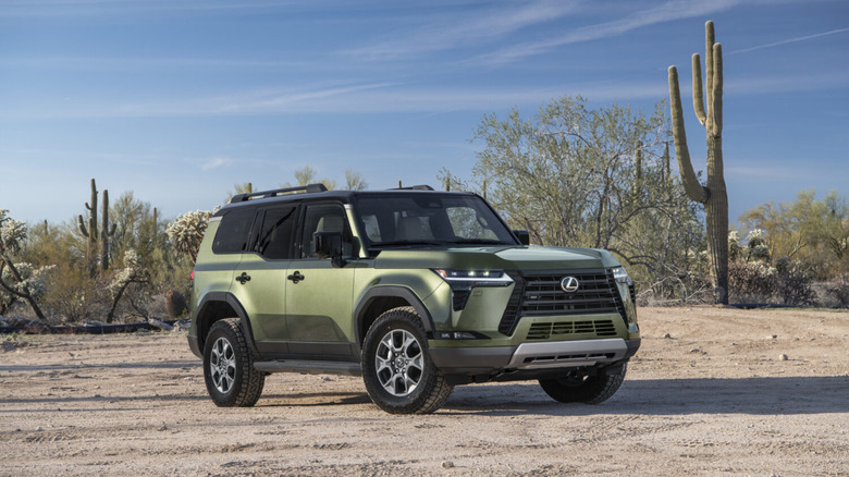 Green Lexus GX 550 parked in desert with cacti in background