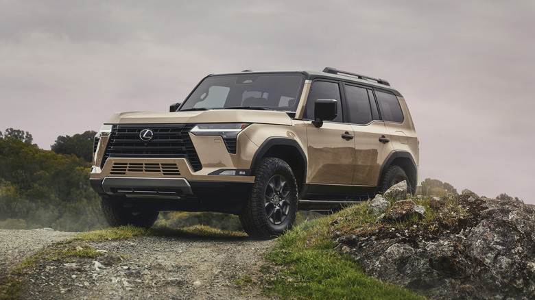 Gold Lexus GX 550 off-roading under cloudy sky