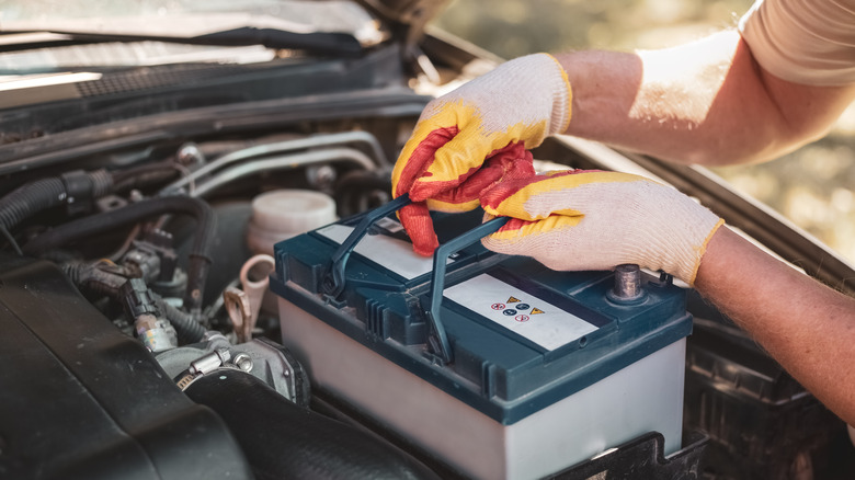 person removing car battery