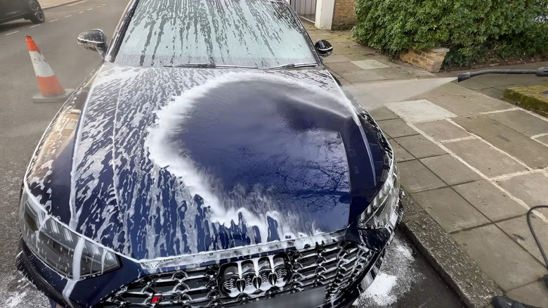 Rinsing an Audi's hood with pressure washer