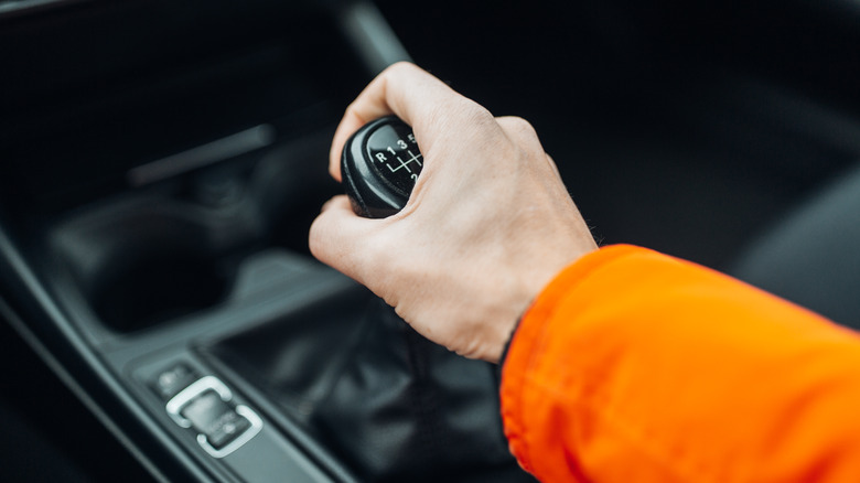 Person using manual gear shifter