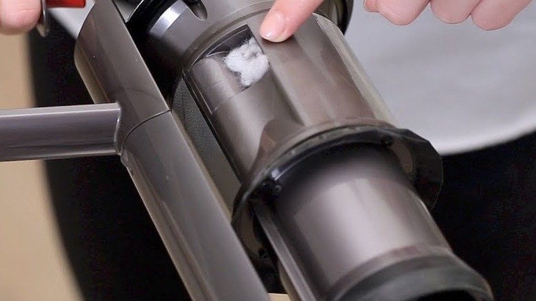 Person pointing to clog in Dyson vacuum