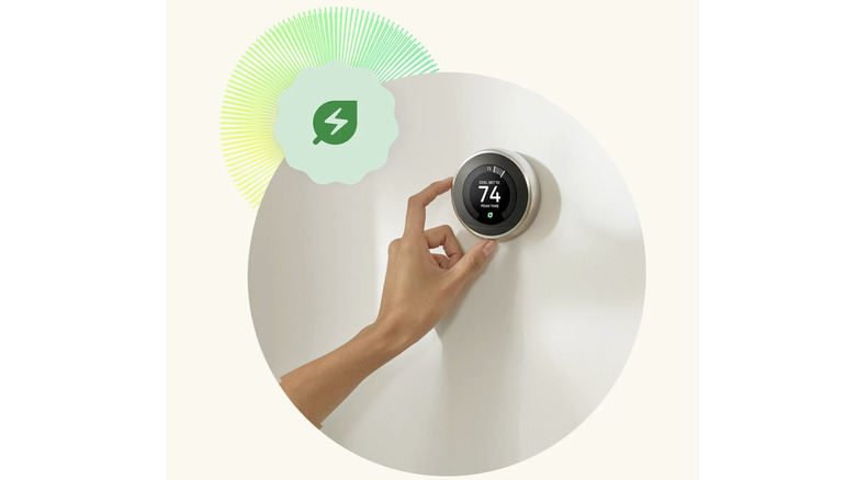 Nest Learning Thermostat being adjusted