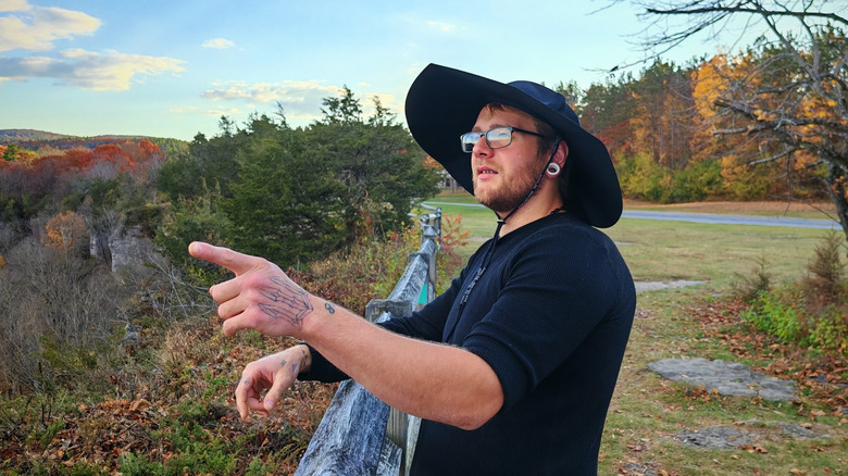 A man wearing the EcoFlow Power Hat while pointing off into the distance