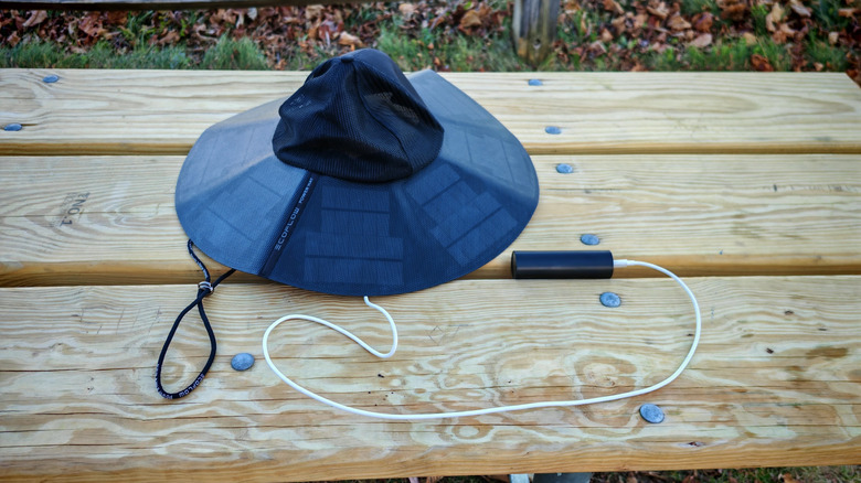 The EcoFlow Power Hat on a picnic table wired into a power bank