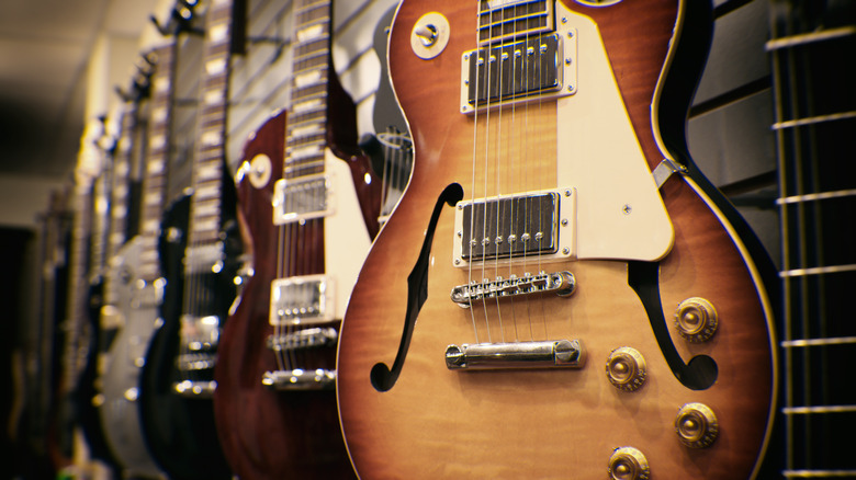 Collection of electric guitars hanging on wall