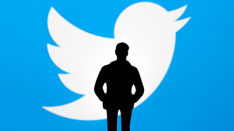 Musk silhouette against Twitter.