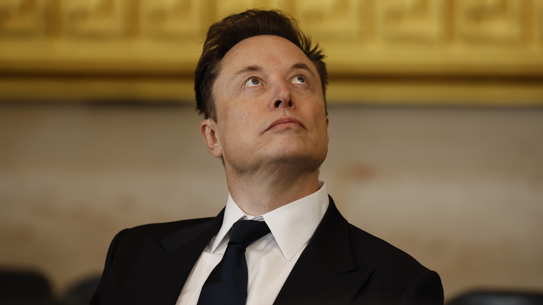 Elon Musk looking up.