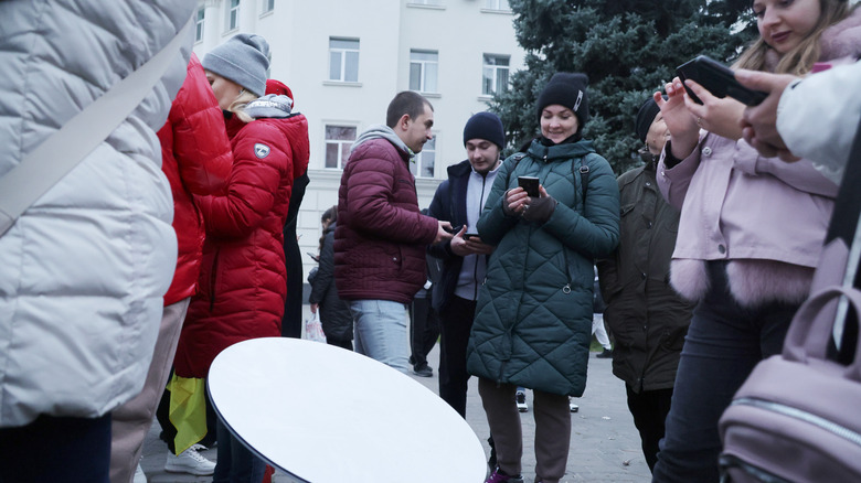 Local residents use internet from the Starlink network, set up by Ukrainian army on November 12, 2022 in Kherson, Ukraine