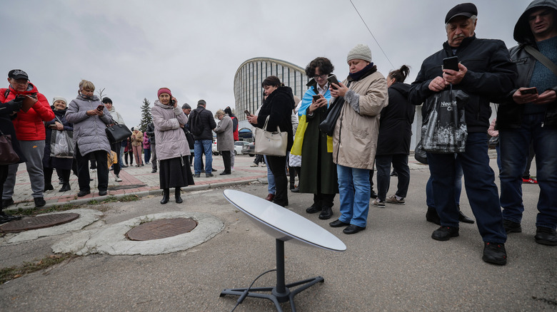 Local residents use internet from the Starlink network, set up by Ukrainian army on November 13, 2022 in Kherson, Ukraine