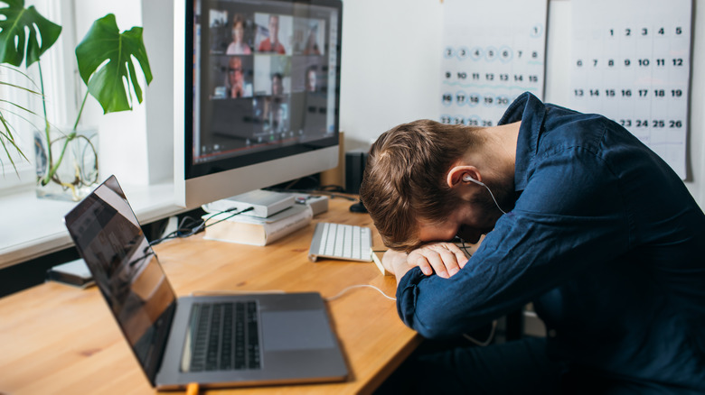 Person sleeping on work desk