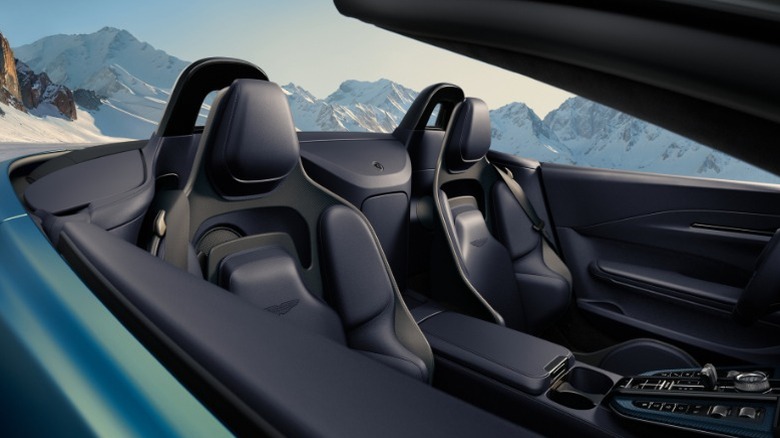 close-up of seats in Aston Martin Vantage Roadster with roof down parked in front of mountains