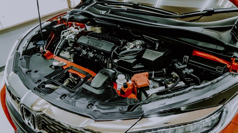 Car with hood open revealing its engine