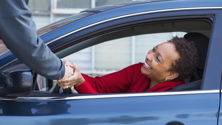 Woman smiling inside car