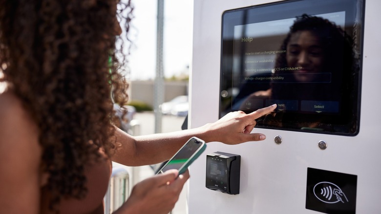 Woman operating an EV charging bay