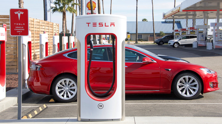 Tesla supercharger and red car