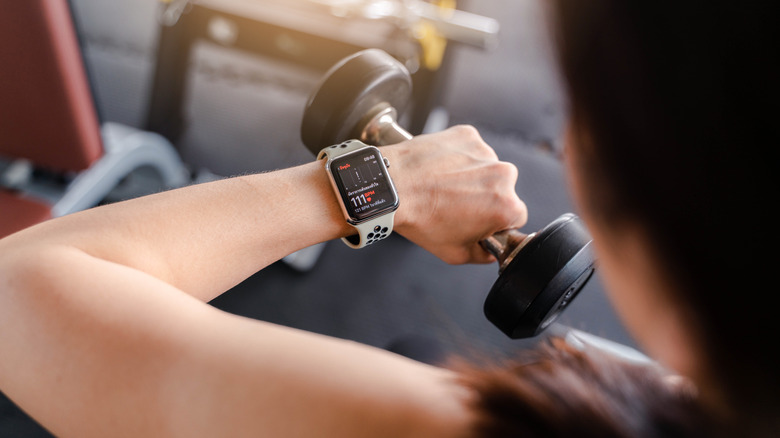 Woman looking at heart rate on Apple Watch