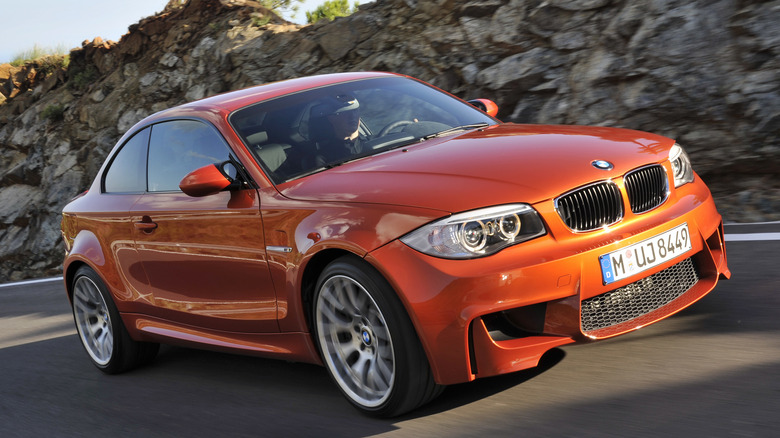 Orange 2011 BMW 1 Series M Coupe on the road