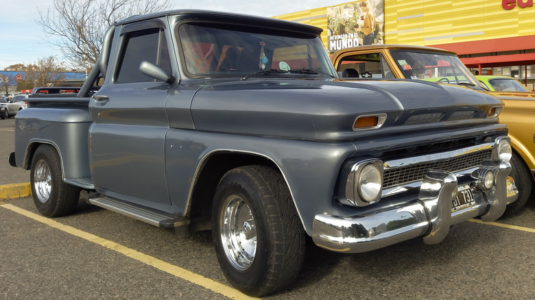 A gray 1960s Chevy C10 in a parking lot