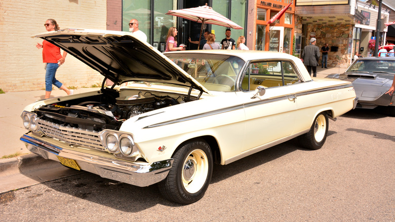 A white 1962 Chevy Bel Air parked on a town street