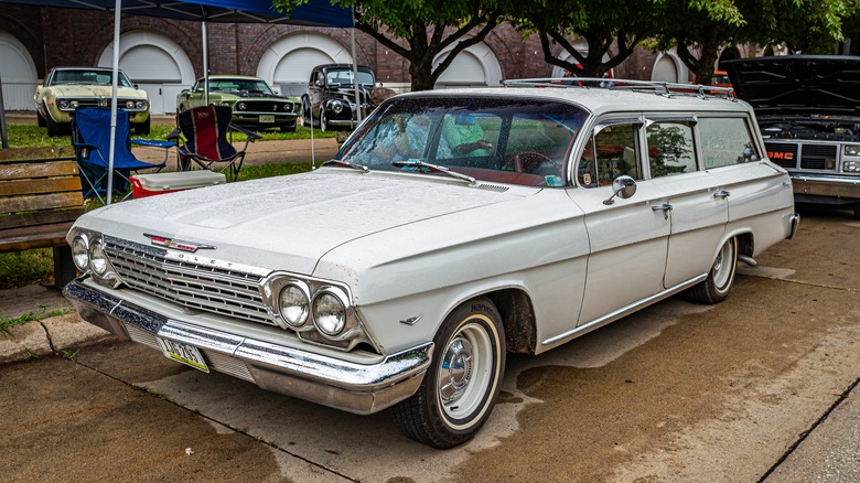 A white 1962 Chevy Biscayne station wagon parked on a city street