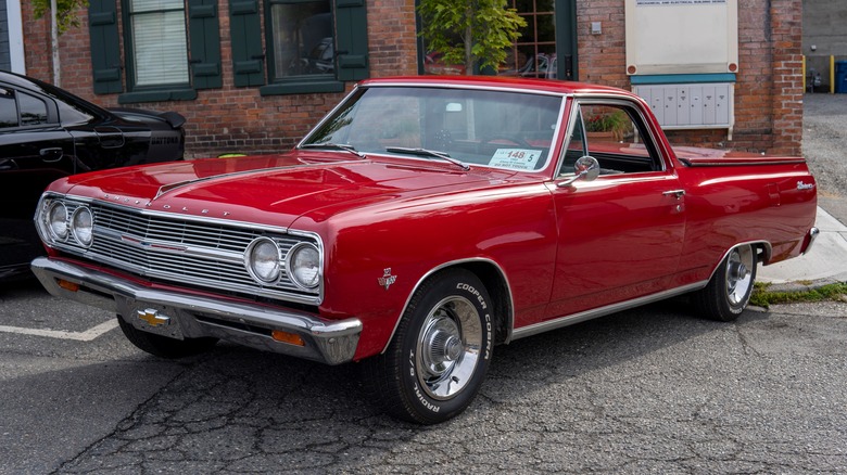 A red 1965 Chevy El Camino parked on a town street