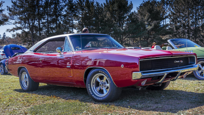 Red 1969 Dodge Charger R/T parked on grass