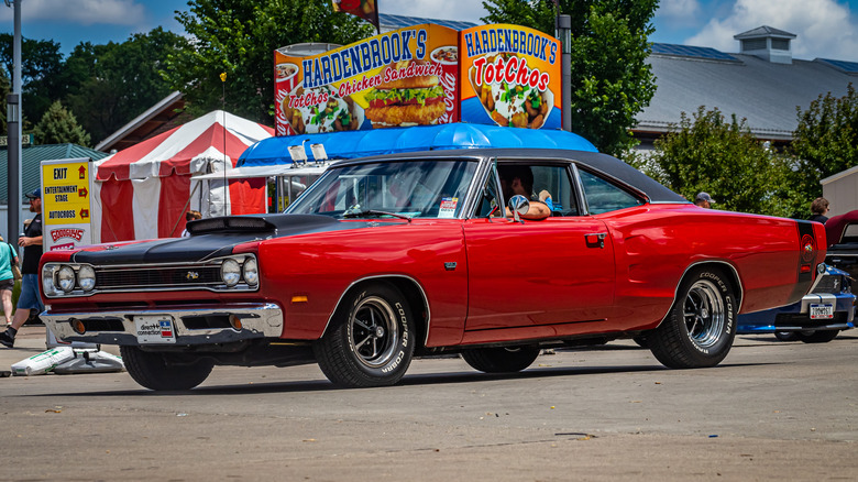 Red 1969 Dodge Super Bee parked on tarmac