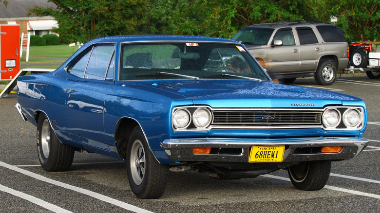 Blue 1968 Plymouth GTX parked in the rain