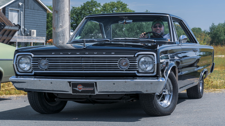 Black 1966 Plymouth Satellite parked with driver