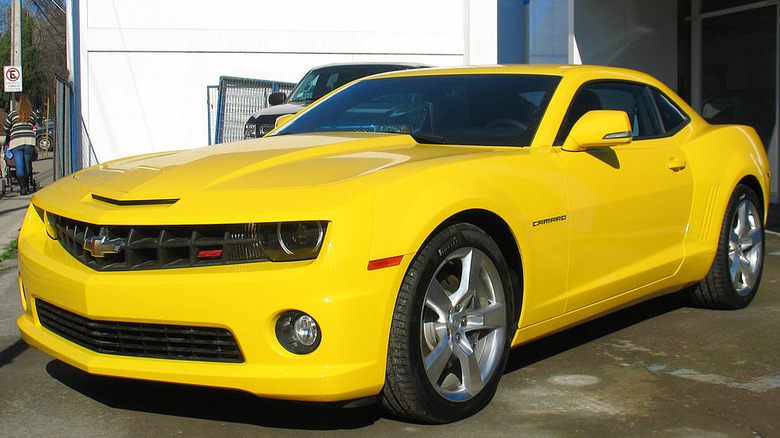 A yellow 2012 Camaro SS sits waiting for its owner.