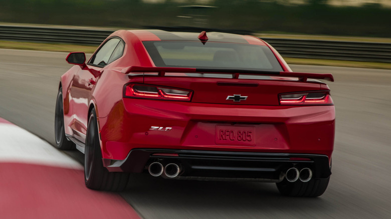 A red 2023 Camaro ZL-1 corners on a track.