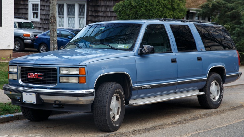 blue gmc suburban parked road