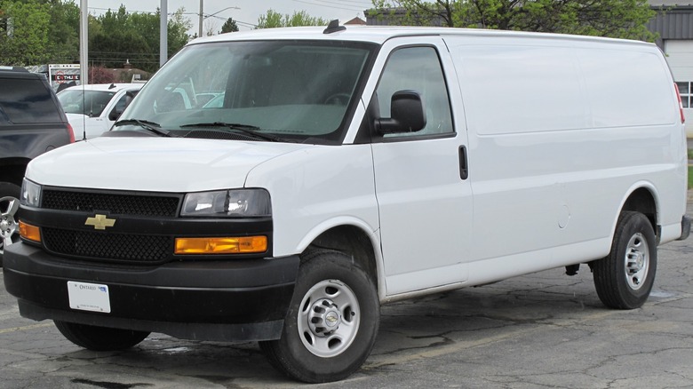 white chevrolet express van parking lot