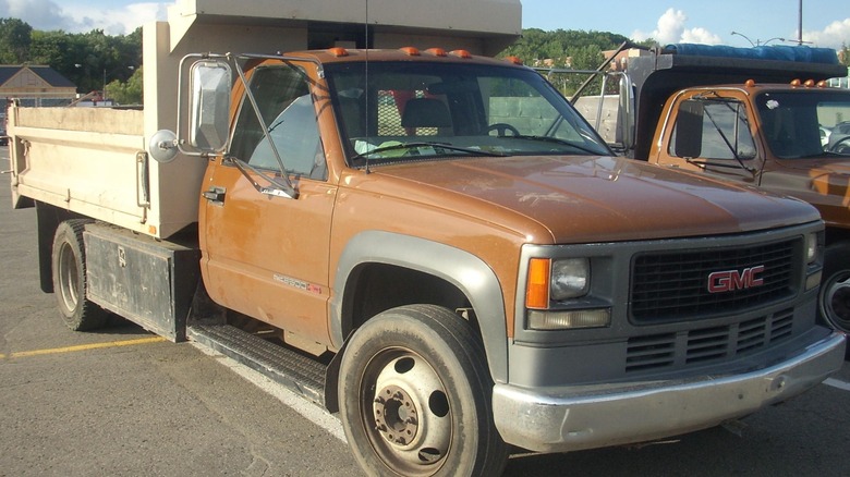 brown c3500 chevrolet truck parking lot