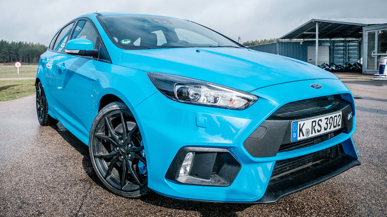 Light blue 2016 Ford Focus RS parked on wet tarmac