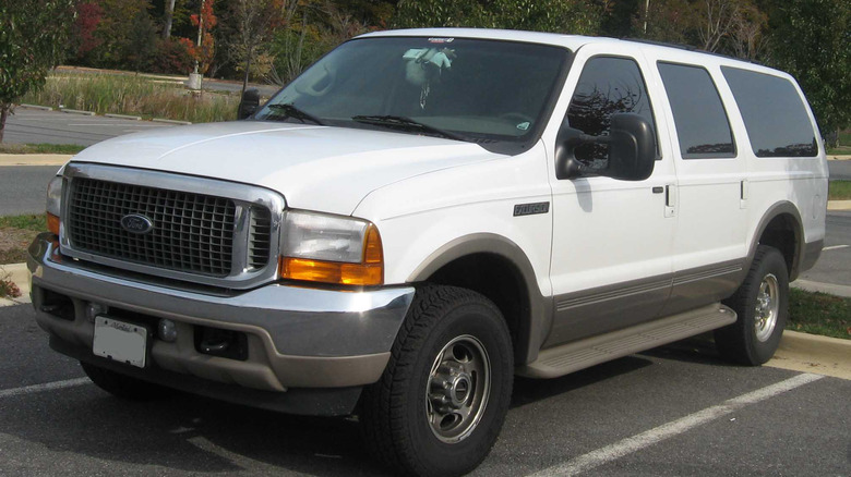 A white 2000 Ford Excursion in a parking space