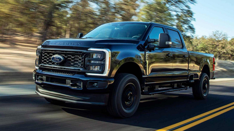 A Ford F-250 driving down the road