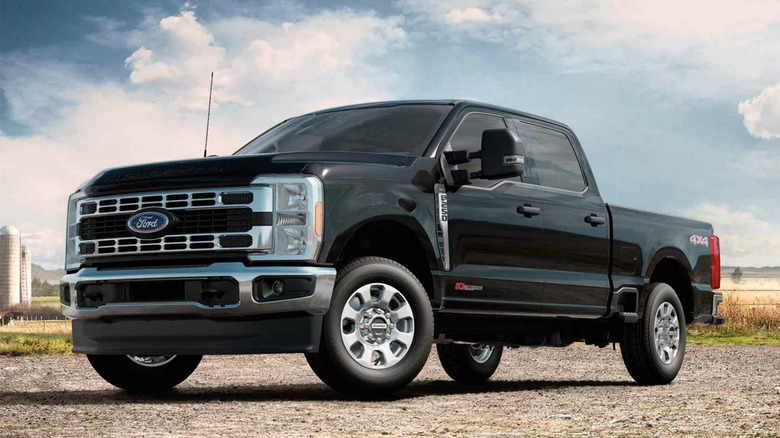 The Ford F-350 on a gravel road near a farm