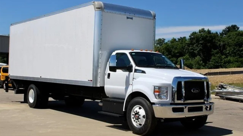 A white Ford F-650 box truck in a parking lot