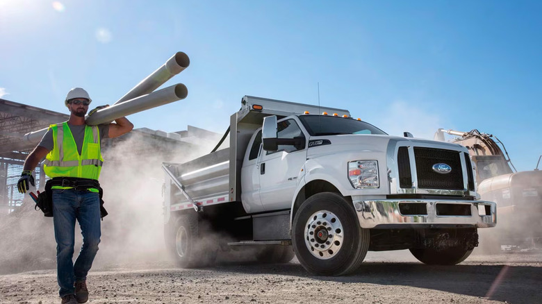 A Ford F-750 in a dump truck configuration on a job site