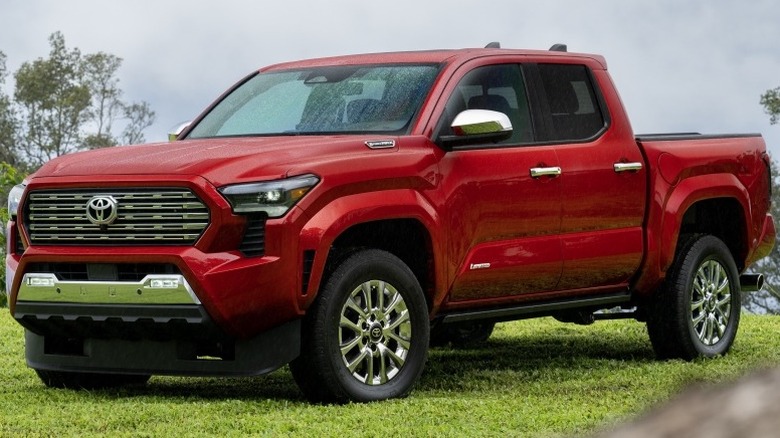 2025 Toyota Tacoma Limited parked on lush green grass with trees in the background